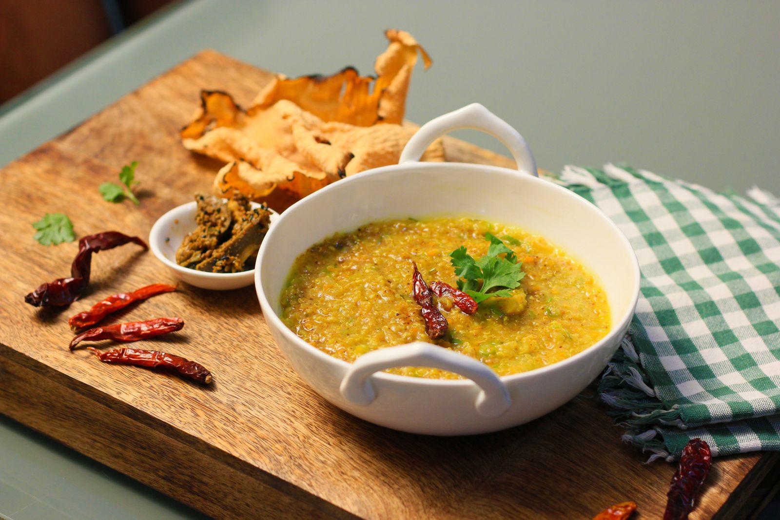 A bowl of dal khichdi topped with red chillies and coriander leaves